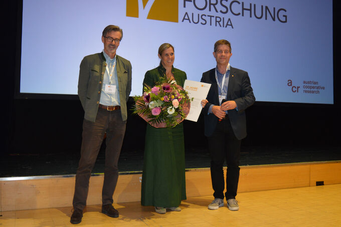 Georg C. Niedersüß, Sylvia Polleres and Gerhard Grüll on stage.
